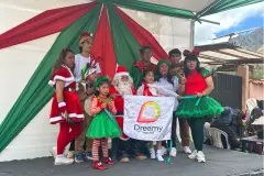Christmas campaign participants with the Dreamy Tours flag in Saylla, 2024